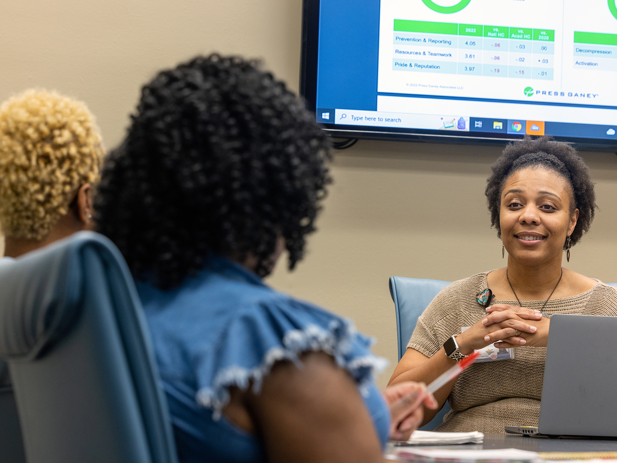 Dr. Kristin Nalls discusses survey data with from far left, Candilyn Tenner, education administrator, and Rochelle Anthony, administrative assistant.